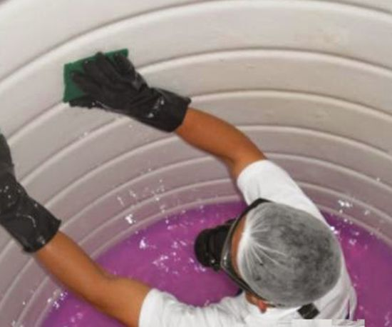 A person is cleaning water tank in Dubai