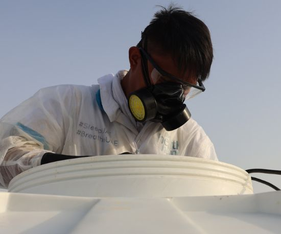 A person is providing Water Tank Cleaning Services in Dubai