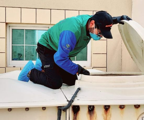 A person is inspecting water tank in Dubai